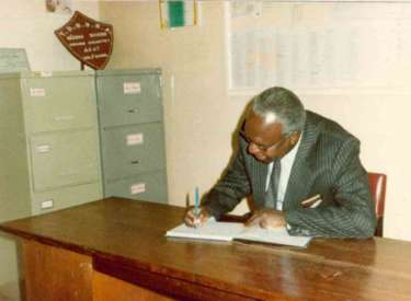 Minister of Education Hon. Simeon Nyachae signing visitors book
